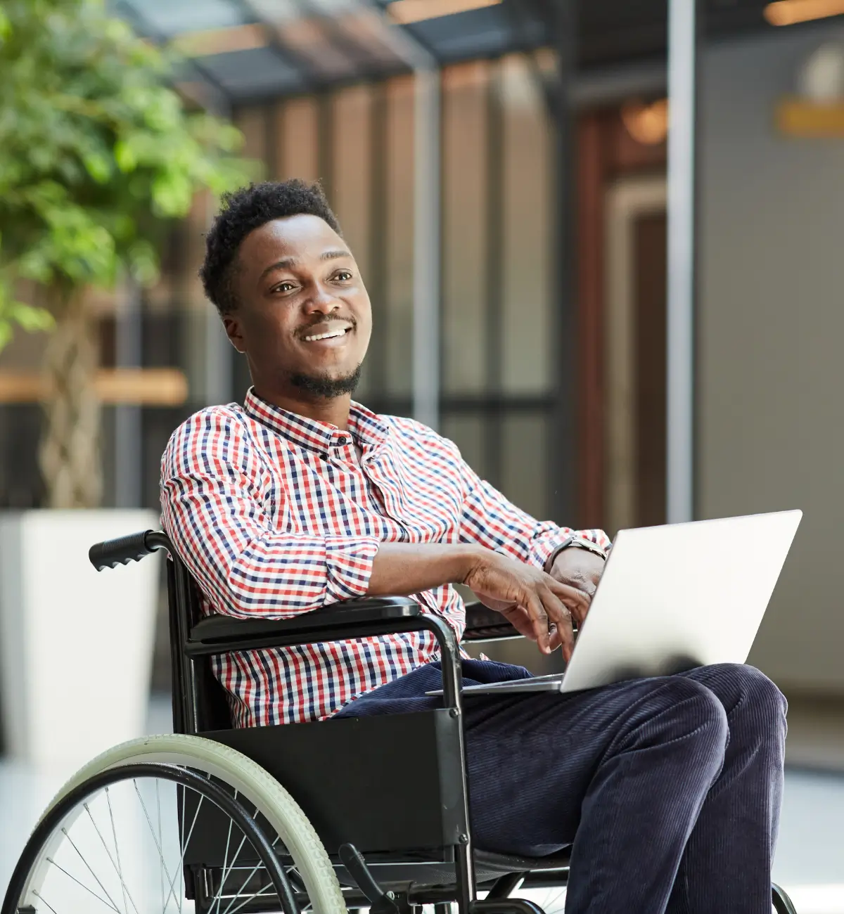 Young disabled man using a laptop